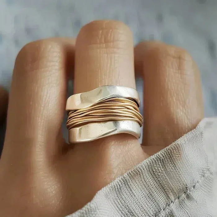 Silver ring intertwined with golden strands